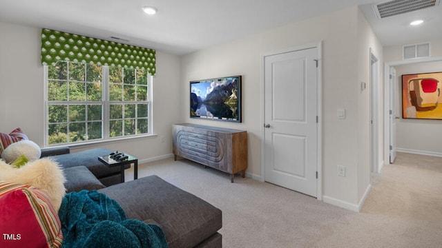 sitting room featuring carpet floors, visible vents, and baseboards