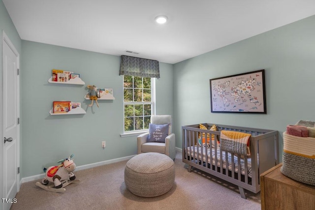 bedroom featuring a nursery area, carpet, visible vents, and baseboards