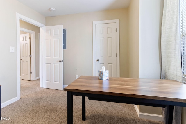 unfurnished office featuring carpet floors and baseboards