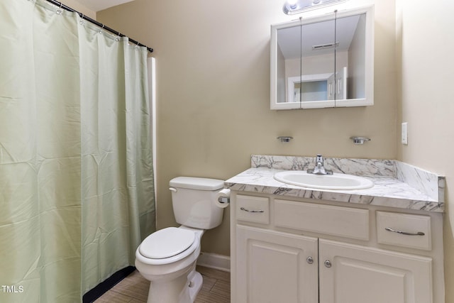 full bathroom with baseboards, visible vents, vanity, and toilet