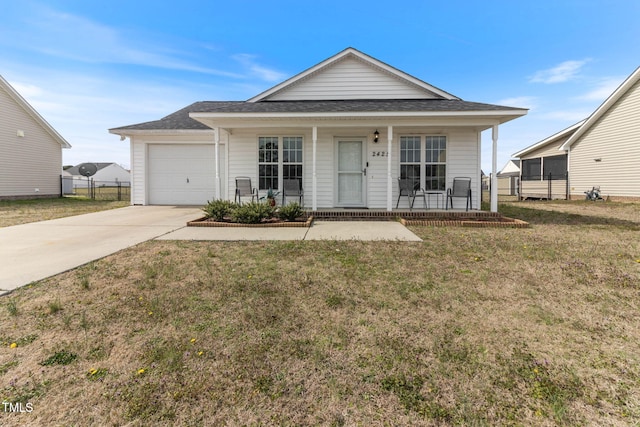 view of front of home featuring a porch, a garage, fence, driveway, and a front yard