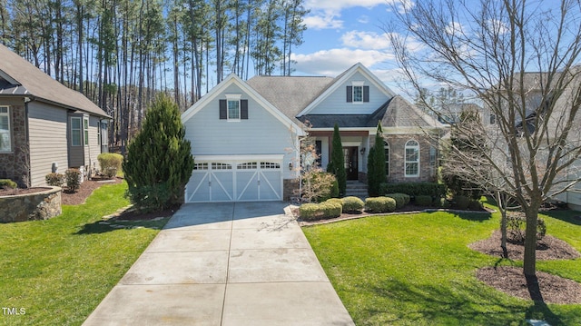 view of front of home featuring a garage, concrete driveway, a front lawn, and stone siding