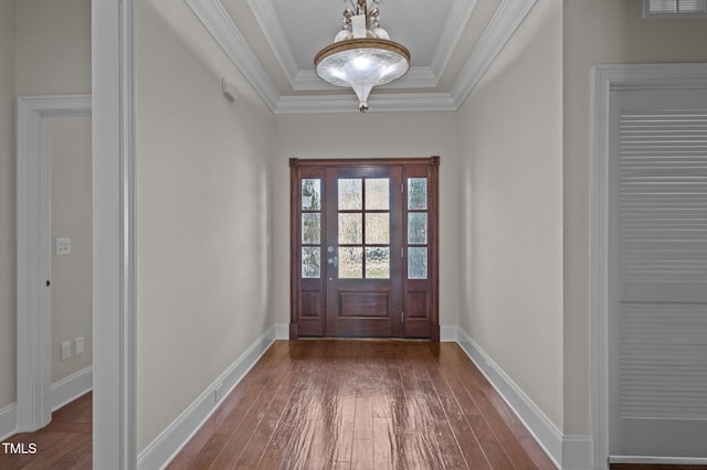 doorway with dark wood-type flooring, crown molding, and baseboards