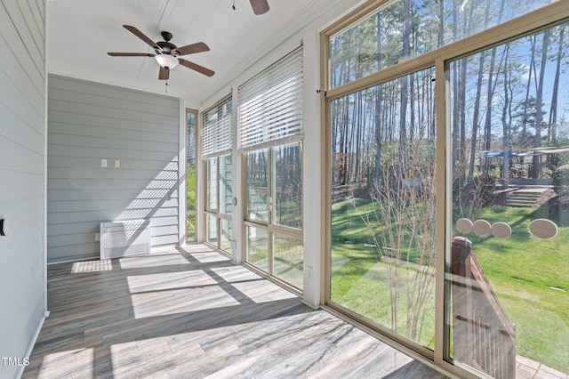 sunroom / solarium featuring ceiling fan