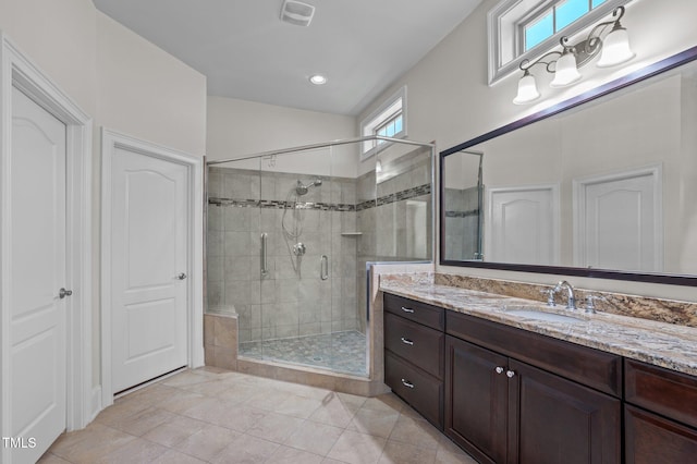 bathroom featuring vanity, visible vents, a stall shower, vaulted ceiling, and tile patterned floors