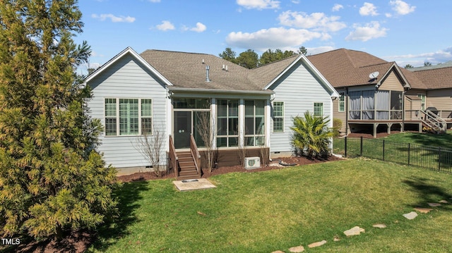 rear view of property with a lawn, fence, roof with shingles, a sunroom, and crawl space