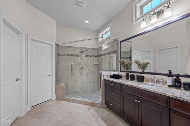 full bath with visible vents, a stall shower, tile patterned flooring, vanity, and vaulted ceiling