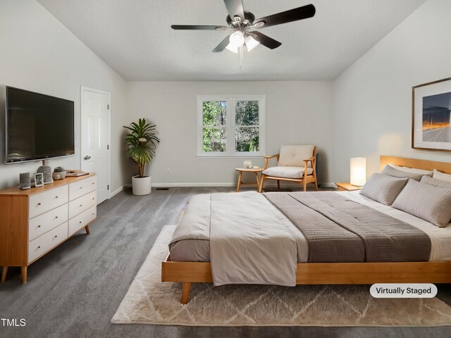 bedroom featuring lofted ceiling, a textured ceiling, carpet floors, a ceiling fan, and baseboards