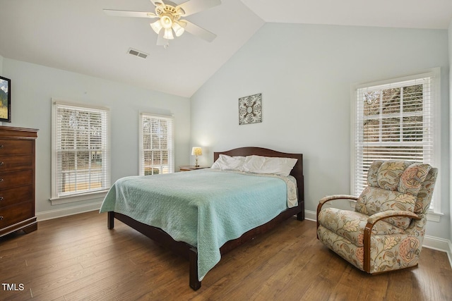 bedroom featuring baseboards, visible vents, vaulted ceiling, and wood finished floors