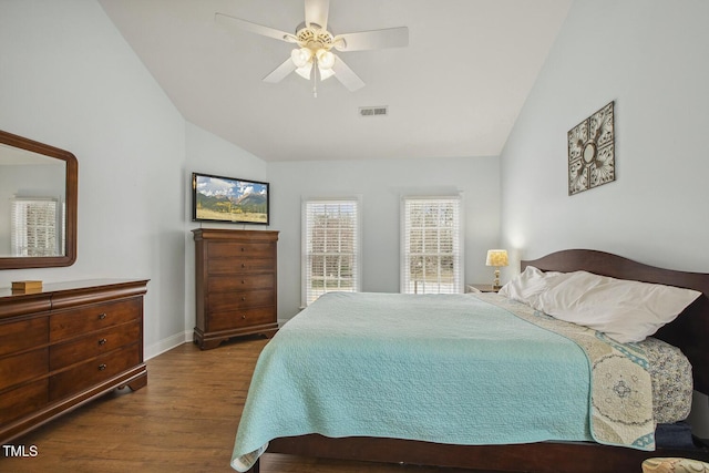 bedroom featuring lofted ceiling, ceiling fan, baseboards, and wood finished floors