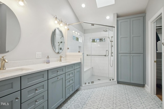 full bath featuring double vanity, a stall shower, and a sink