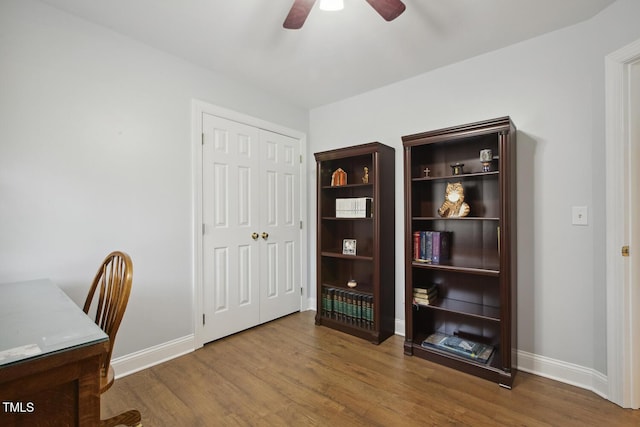 office area with ceiling fan, baseboards, and wood finished floors