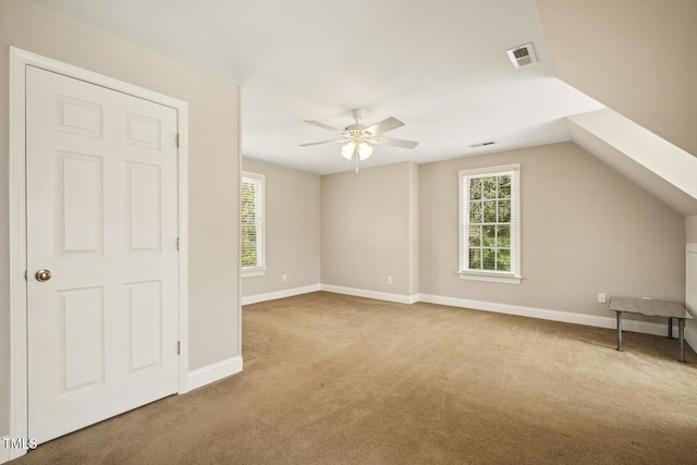 bonus room featuring carpet floors, visible vents, plenty of natural light, and baseboards