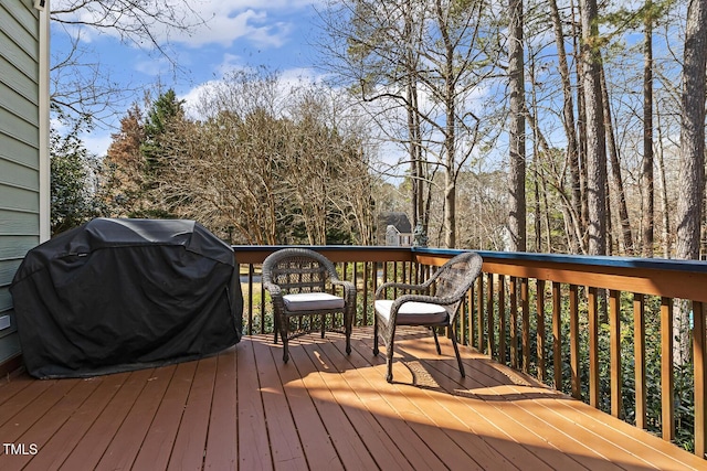 wooden terrace featuring a grill