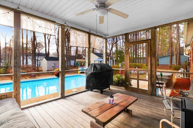 sunroom / solarium featuring a ceiling fan and a healthy amount of sunlight