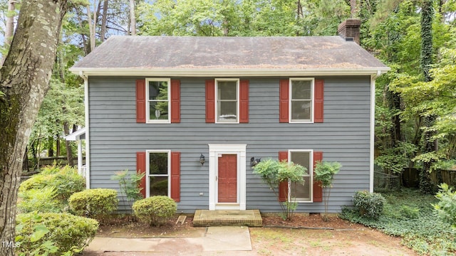 colonial home featuring a chimney