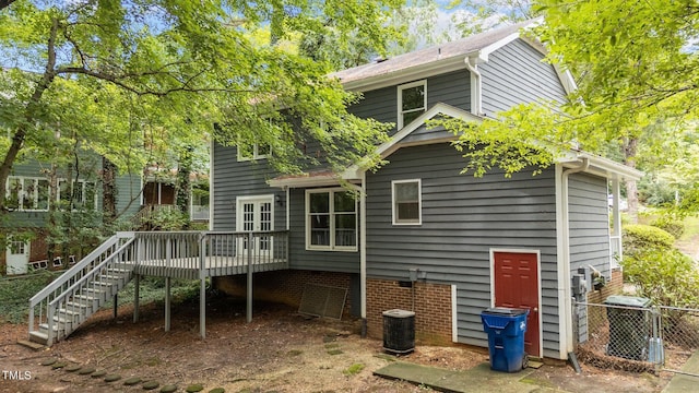 back of property featuring stairway, a deck, and central AC unit