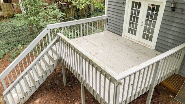 wooden deck featuring fence and french doors