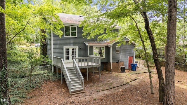 back of house featuring a wooden deck, stairs, fence, and french doors