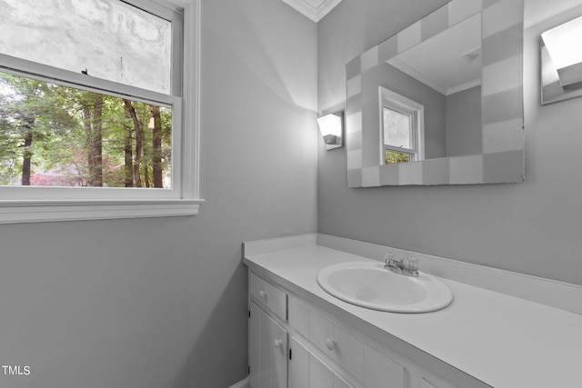 bathroom featuring vanity, visible vents, and crown molding