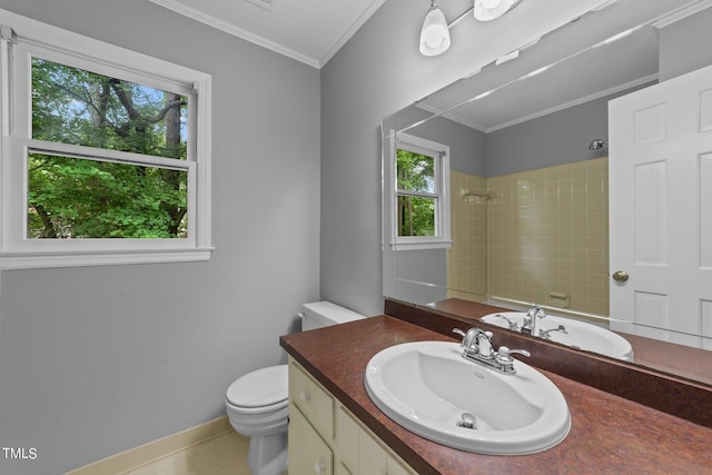 full bath featuring baseboards, toilet, ornamental molding, a tile shower, and vanity