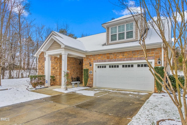 view of front facade with stone siding and concrete driveway