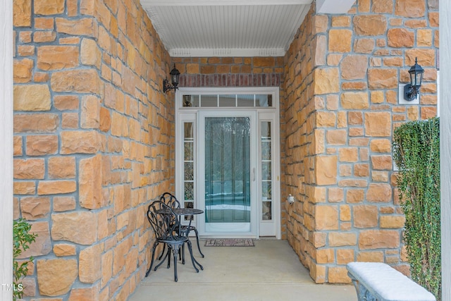 doorway to property with brick siding