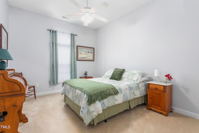 bedroom featuring ceiling fan, visible vents, baseboards, and light colored carpet