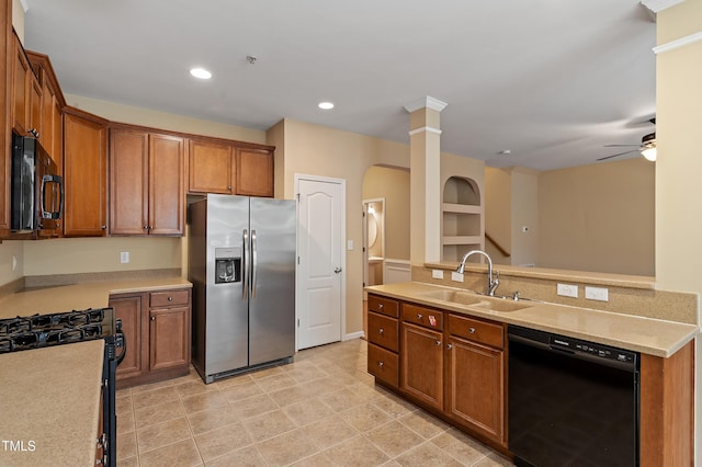 kitchen with brown cabinetry, recessed lighting, a sink, black appliances, and light countertops