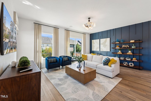 living area with light wood finished floors and a chandelier