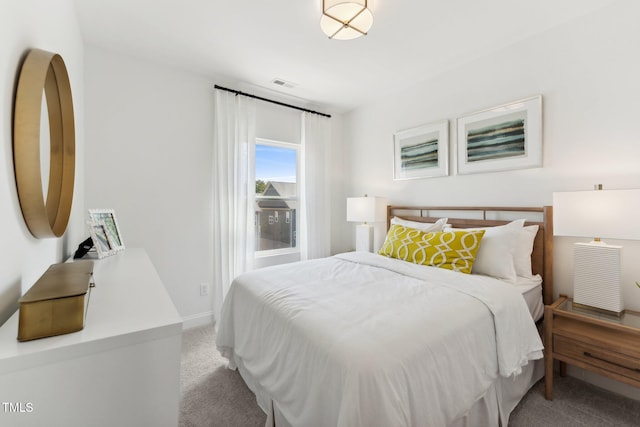 bedroom with carpet, visible vents, and baseboards