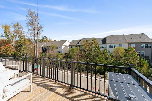 wooden terrace featuring a residential view