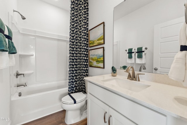 bathroom with wood finished floors, vanity, toilet, and shower / bathtub combination with curtain