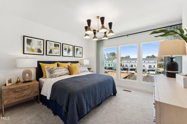 bedroom with light carpet, visible vents, a chandelier, and baseboards