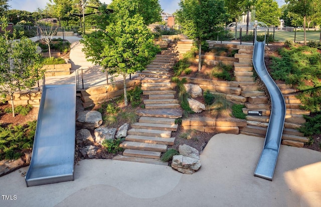 view of community with stairs and fence