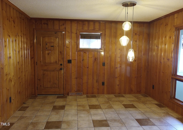 entrance foyer with wood walls and visible vents