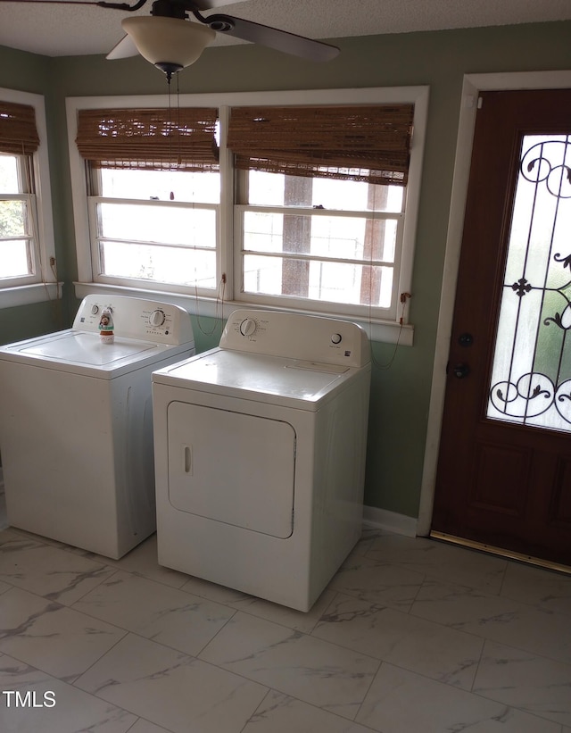 washroom featuring marble finish floor, ceiling fan, washing machine and clothes dryer, and laundry area