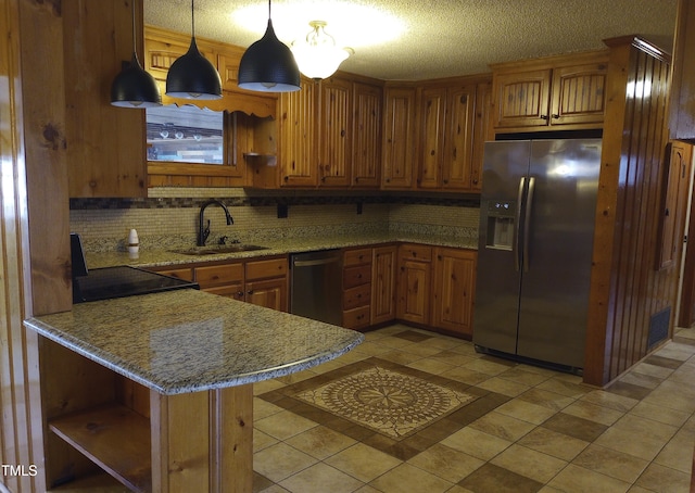 kitchen with appliances with stainless steel finishes, brown cabinets, a peninsula, open shelves, and a sink