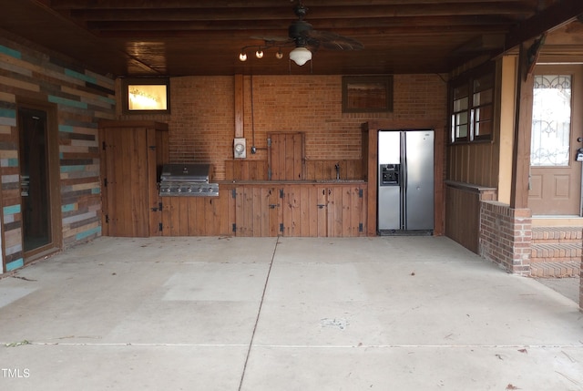 garage featuring a ceiling fan and stainless steel fridge