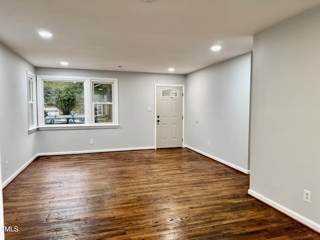 unfurnished room featuring recessed lighting, dark wood finished floors, and baseboards