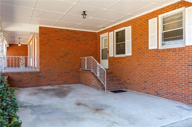 exterior space with a patio and brick siding