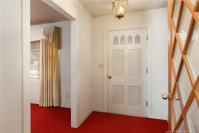 entryway with carpet and baseboards