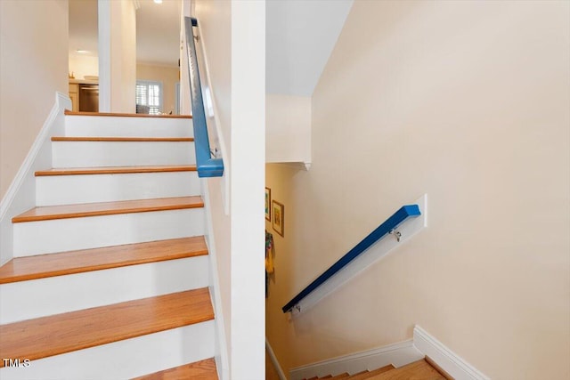 staircase featuring baseboards