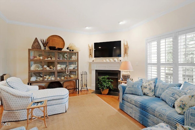 living room featuring a fireplace with flush hearth, wood finished floors, and crown molding