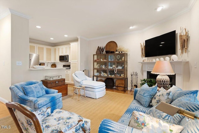 living area with light wood-style flooring, a fireplace, ornamental molding, and recessed lighting