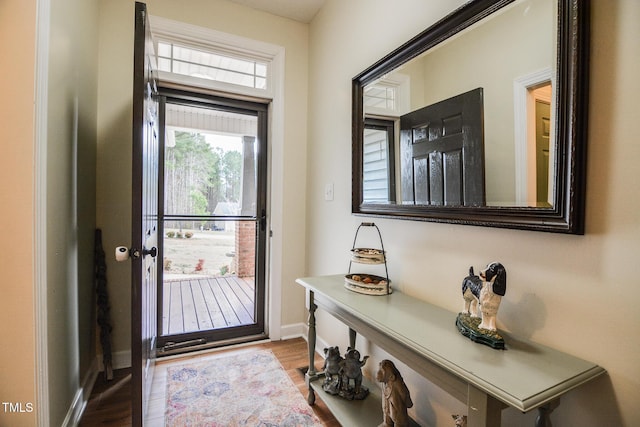 entryway featuring baseboards and wood finished floors