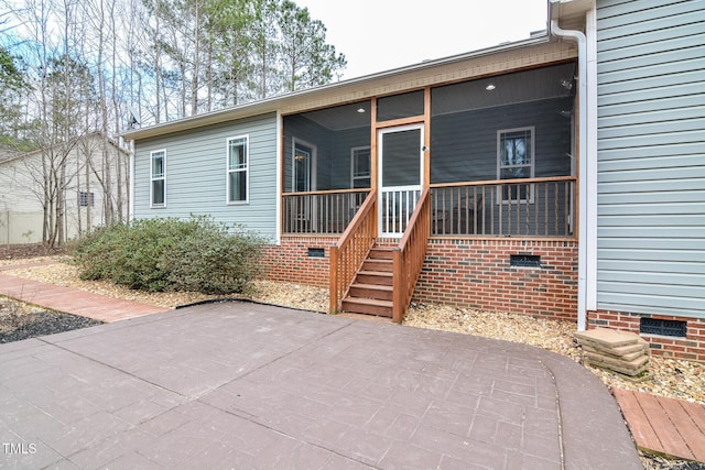 rear view of house with crawl space