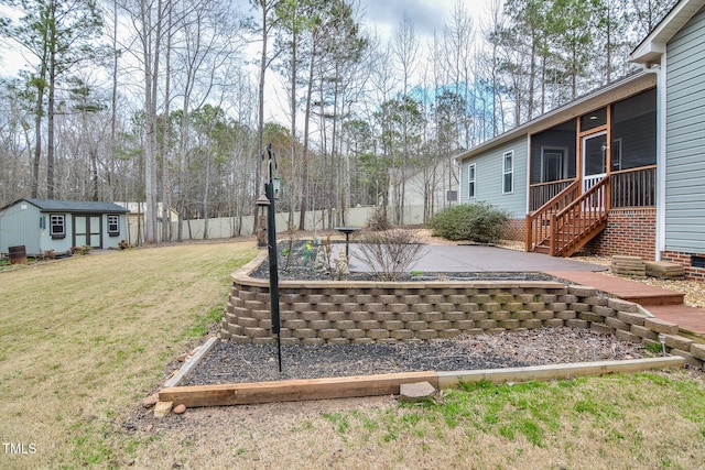 view of yard with a sunroom, a fenced backyard, a patio, and an outbuilding