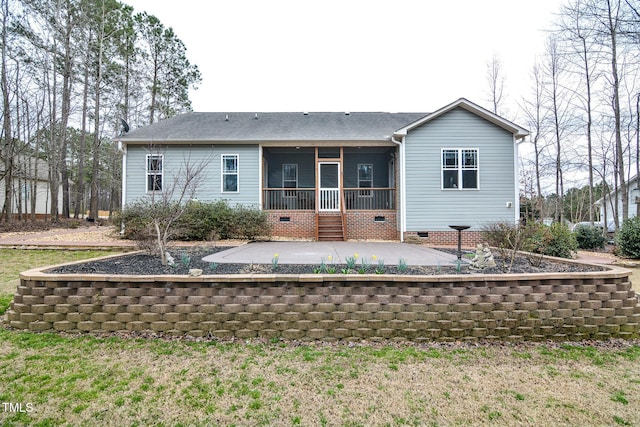 back of house with a patio, roof with shingles, crawl space, and a sunroom