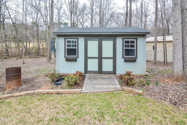 view of shed featuring fence